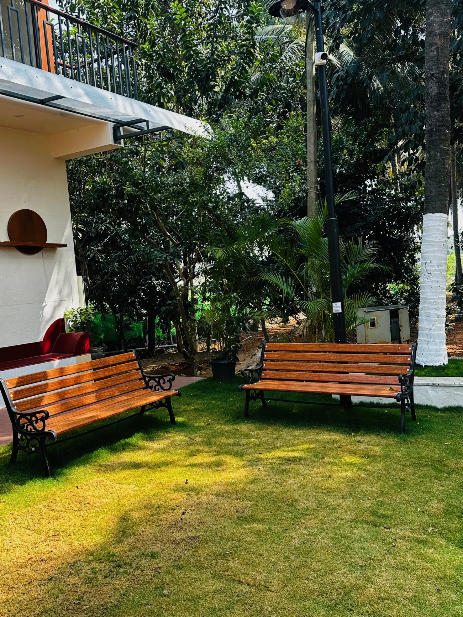 Garden benches and seating area near the farmhouse at Amal Farms