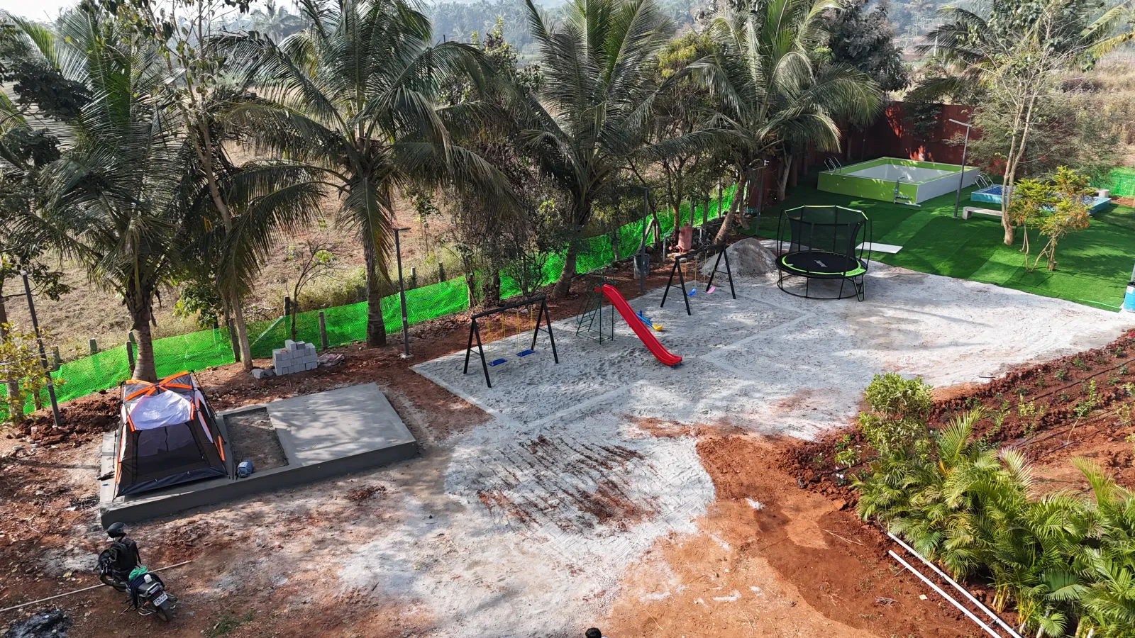 Drone view of children playground with slides and swings at Amal Farms