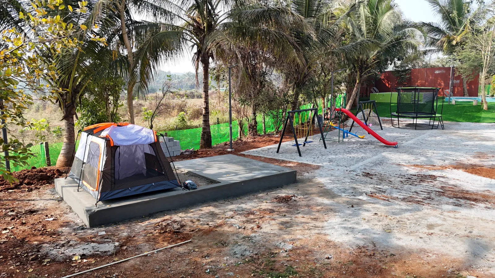 Camping tent and playground with slides at Amal Farms coconut grove