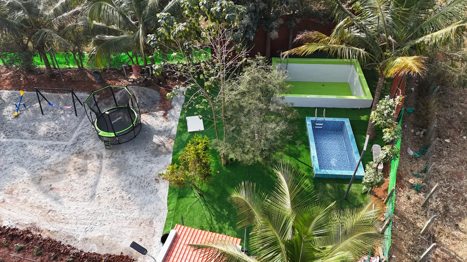 Aerial view of the swimming pool and play area at Amal Farms