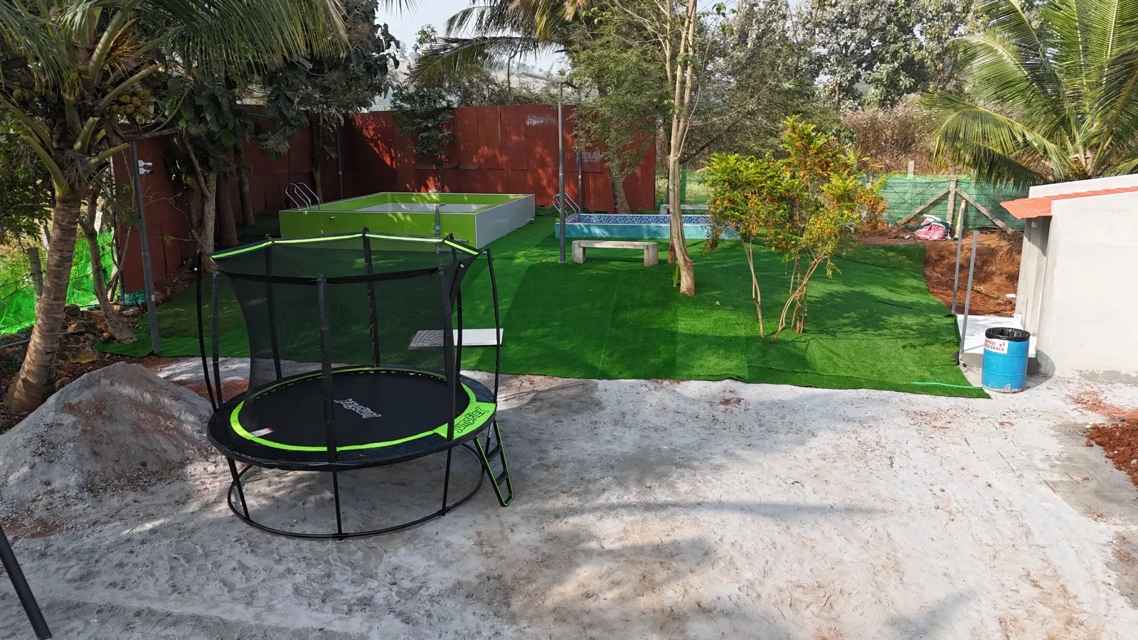 Trampoline and artificial turf play area at Amal Farms